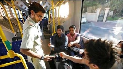 Hamad Al Jallaf checks the Nol cards of bus passengers.