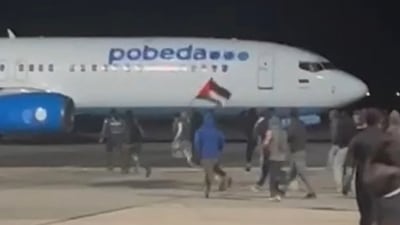 Men were seen trying to climb on to idling planes