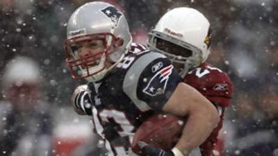 The New England Patriots wide receiver Wes Welker tries to break a tackle by Arizona Cardinals safety Adrian Wilson.