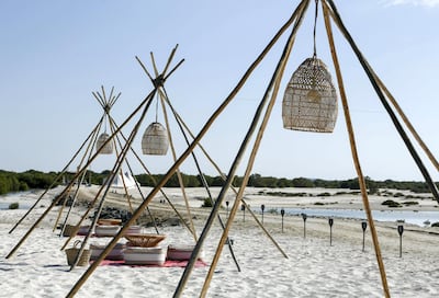 Outdoor seating for dinner at Pura Eco Retreat on Jubail Island. Khushnum Bhandari / The National