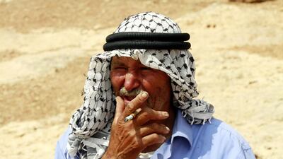 A bedouin farmer smokes a cigarette on the outskirts of the northern West Bank city of Tubas. Alaa Badarneh / EPA