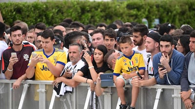 Juventus supporters wait for Ronaldo at the Juventus medical center. AFP