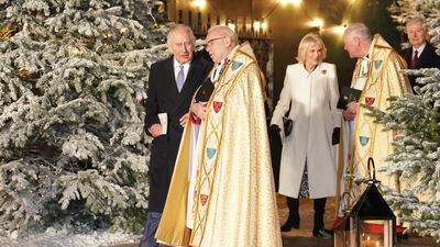King Charles, Dean Hoyle and Queen Consort Camilla at the carol service. PA