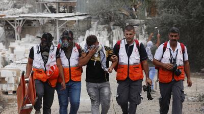 Palestinian medics help an injured protester in Beita, a village in the West Bank blighted by violent clashes in the past year. EPA