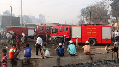 Rohingya refugees children watch fire engines at the site of Monday's fire at a Rohingya refugee camp in Balukhali, southern Bangladesh. AP Photo