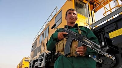 An Afghan policeman stands guard near a new railway track inaugurated in Hairatan. In the harsh desert heat on the northern border with Uzbekistan, workers are hammering down the tracks of Afghanistan's first railway which the government says is a revolutionary project that could revive the poverty-stricken, war-ravaged, landlocked country's status as a thriving "silk road" trade hub.