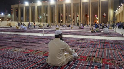Worshippers sit outside of the Majidul Kabeer Grand Mosque in Kuwait City, Kuwait, on June 11, 2018. Noufal Ibrahim / EPA