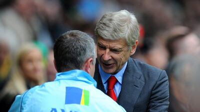 Arsenal manager Arsene Wenger greets Norwich City manager Neil Adams before their Premier League season-ending match on Sunday. Steve Bardens / Getty Images / May 11, 2014
