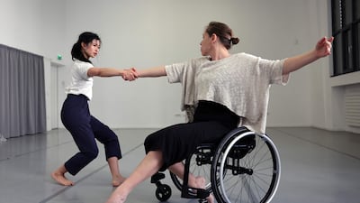 A dancer from the Paris Opera dances with a disabled dancer in her wheelchair during a rehearsal of the ballet "Passage" in Paris, on February 19, 2022. AFP