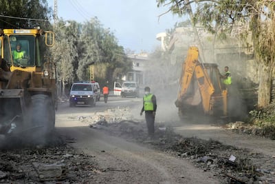 First responders at the site of an Israeli air strike in Srifa. AFP