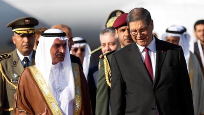 Ruler of Fujairah, Sheikh Hamad Bin Mohammed Al Sharqi, left, walks next to Tunisian Presidential Advisor for political affairs, Habib Essid, upon his arrival at Tunis-Carthage international airport to attend the Arab Summit, in Tunis, Tunisia. Reuters