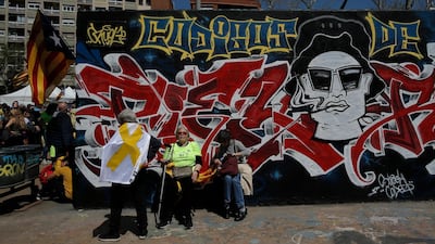 Demonstrators rest during the protest. More than 300,000 Catalan separatists rallied in downtown Barcelona, according to local authorities. AP/Manu Fernandez