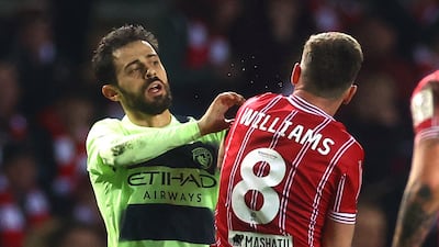 Manchester City's Bernardo Silva and Bristol City's Joe Williams clash. Reuters