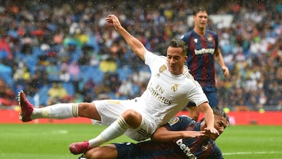Lucas Vazquez of Real Madrid is tackled by Oscar Duarte of Levante. Getty Images