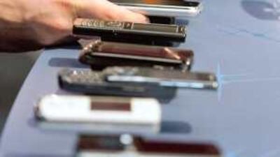 Mobile phone handsets are displayed at the Mobile World Congress, in Barcelona last year: the congress, the largest wireless industry conference, is expected to bring together more than 50,000 industry executives from some 1,300 companies.