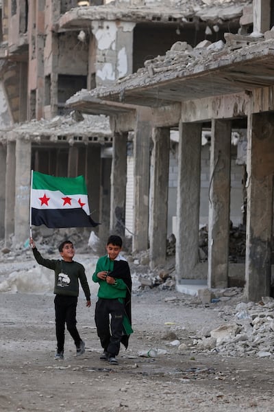 Boys in the war-damaged Damascus suburb of Daraya, Syria, on December 5, before celebrations marking the first anniversary of the removal of the Bashar Al Assad regime. AP Photo
