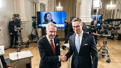 Mr Haavisto and Mr Stubb shake hands at Helsinki City Hall during the election. Bloomberg