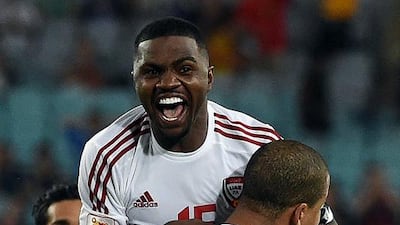 Ismail Al Hammadi, centre, hugs Ismail Ahmed after his goal during the quarter-final match between Japan and UAE at the AFC Asian Cup in Sydney on January 23, 2015. AFP PHOTO / Saeed KHAN