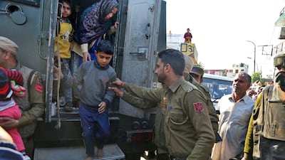 Indian villagers disembark from a military vehicle after being removed to safety following shelling from the Pakistan side of the border in Ranbir Singh Pura district of Jammu and Kashmir on January 19, 2018. Channi Anand / AP Photo
