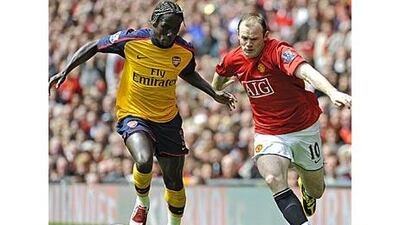 United's Wayne Rooney, right, and Arsenal's Bacary Sagna battle at Old Trafford last season.