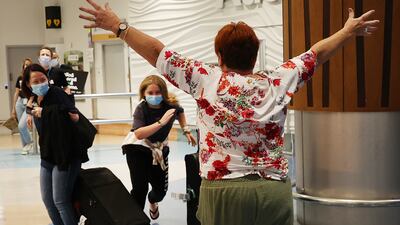 Bette-May Waine, right, welcomes her granddaughter Mackenzie Waine and family from Australia to Auckland after New Zealand borders reopened to Australian tourists on April 12. Getty Images