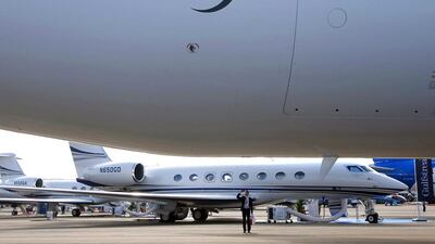 A visitor takes photos of a Qatar Airways Boeing 787 Dreamliner aircraft on display at the Singapore Airshow. Edgar Su / Reuters