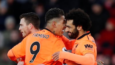 Liverpool's Mohamed Salah, right, celebrates scoring Liverpool's second goal in a 2-0 win over Southampton. Roberto Firmino, centre, scored Liverpool's first. Eddie Keogh / Reuters