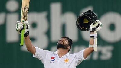 Pakistani batsman Azhar Ali raises his bat as he celebrates after scoring a century. Aamir Qureshi / AFP