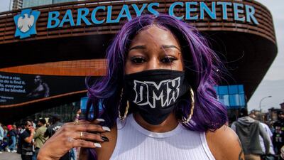 Cherrelle McClary, 32, poses for a portrait with her DMX mask during a memorial at Barclays Centre. AP