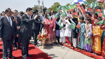 Chinese president Xi Jinping waving to Pakistani children as his Pakistani counterpart Mamnoon Hussain and Pakistani prime minister Nawaz Sharif (C, back) look on at Islamabad airport in Islamabad, Pakistan. EPA