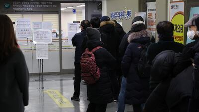People wait in line to apply for an unemployment allowance at a welfare centre in Seoul, South Korea, on January 3, 2022. EPA