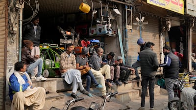 Shopkeepers wait for the power cut to end, in Lahore, northern Pakistan. The blackout lasted several hours. AP Photo