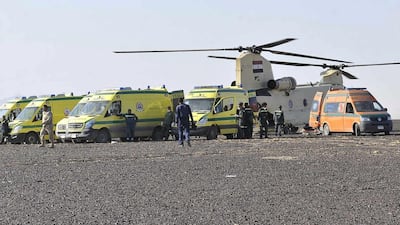 Ambulances and a military helicopter stand by to transport bodies after a plane crashed in Hassana, Egypt. A Russian aircraft carrying 224 people, including 17 children, crashed Saturday in a remote mountainous region in the Sinai Peninsula. Suliman el-Oteify / Egypt Prime Minister’s Office via AP