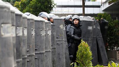 Police officer stands guard at a barricade during a protest near the Election Supervisory Agency (Bawaslu) headquarters in Jakarta, Indonesia. Reuters
