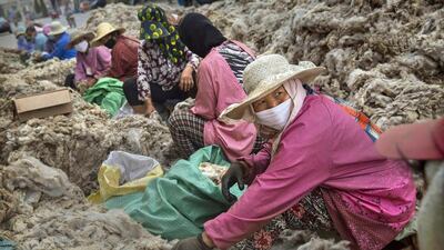 Workers sort sheep’s wool before it is processed and bleached at a factory near Zhangzhou, China. The facility prepares wool to be used in the manufacturing of footwear and clothing for export to western markets and for consumption within China. Kevin Frayer / Getty Images