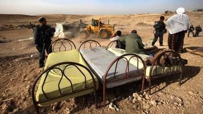 Bedouins stand by their furniture, which was removed from living quarters being demolished on the Bedouin site of al-Araqib.