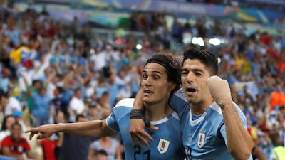 Edinson Cavani, left, of Uruguay celebrates a goal with teammate Luis Suarez against Chile at the Maracana. The 1-0 win saw Uruguay progress to the quarter-finals as Group C winners, with Chile also advancing in second place. EPA
