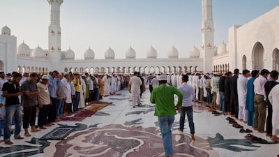 Worshippers gather and pray at the Sheikh Zayed Grand Mosque in Abu Dhabi. Antonie Robertson / The National