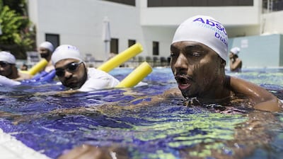 Kenyan Eddie Umar, 35, learns to swim despite his fear of water at the Le Meriden Hotel in Dubai on Wednesday. Christopher Pike / The National