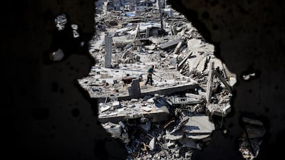 A Palestinian man stands on the rubble of buildings destroyed during the war in Gaza City, October 7, 2026. REUTERS / Mahmoud Issa TPX IMAGES OF THE DAY