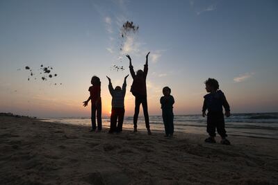 Young displaced Palestinians spend time on a beach near their tents on the Nuseirat beach road in the central Gaza Strip. AFP