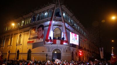 Pedro Castillo celebrates with his running mate Dina Boluarte after being declared president-elect of Peru by election authorities, from the balcony of his campaign headquarters in Lima.