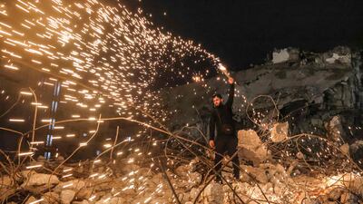 A man swings a homemade sparkler after sunset in Gaza city. AFP