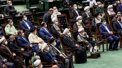 Former Iranian President Hassan Rouhani and Iran's new President Ebrahim Raisi attend the swearing-in ceremony at the parliament in Tehran, Iran