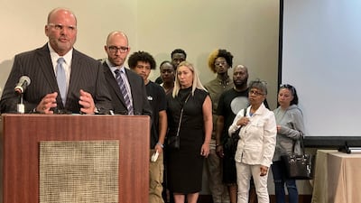 Lawyer Rex Elliott addresses reporters with the extended family of Donovan Lewis behind him in Columbus, Ohio. AP