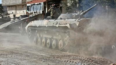 A Syrian army APC rolls in the former rebel-held area of Beit Nayem in the Eastern Ghouta region on the outskirts of the capital Damascus on March 6, 2018. AFP