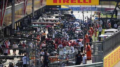 Cars back in the pit lane after the early crash.