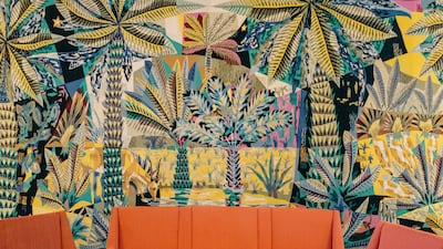 The salon's walls are covered, floor to ceiling, by handwoven mergoum tapestries in vibrant colors depicting scenes from different Tunisian landscapes. Erin Clare Brown / The National