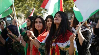 People wave Kurdish flags on September 22, 2017, on the Place de la Republique in Paris, during a gathering in support of a "yes" vote ahead of an independence referendum for Iraqi Kurdistan due to be held on September 25. Zakaria Abdelkafi / AFP