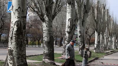 The unexploded tail section of a 300mm rocket, which appear to contained cluster bombs, is embedded in the ground after shelling in Lysychansk. AFP